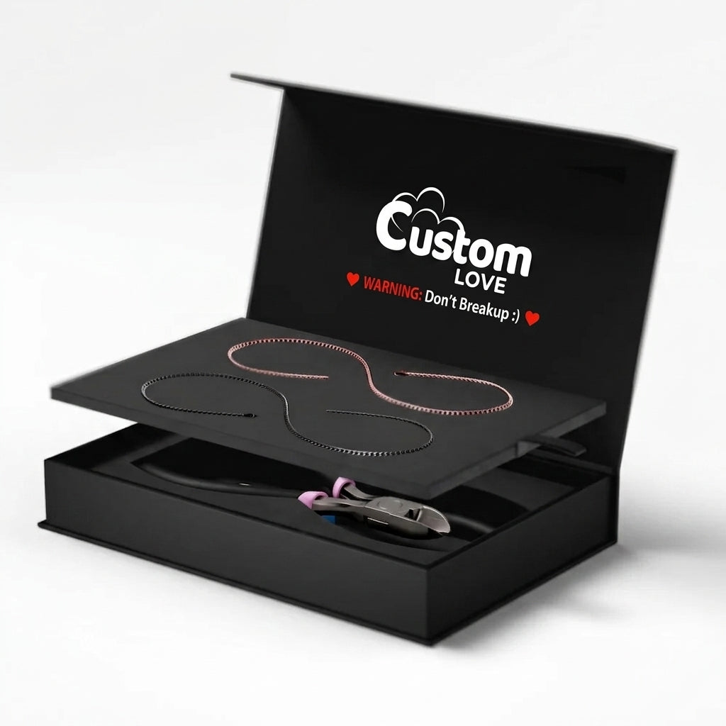 Black jewelry box with 'Locked' design and necklaces inside on a white background