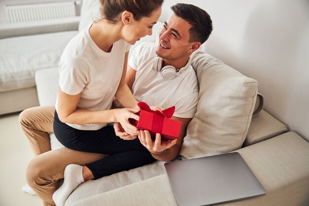 wife-giving-present-her-pleased-spouse