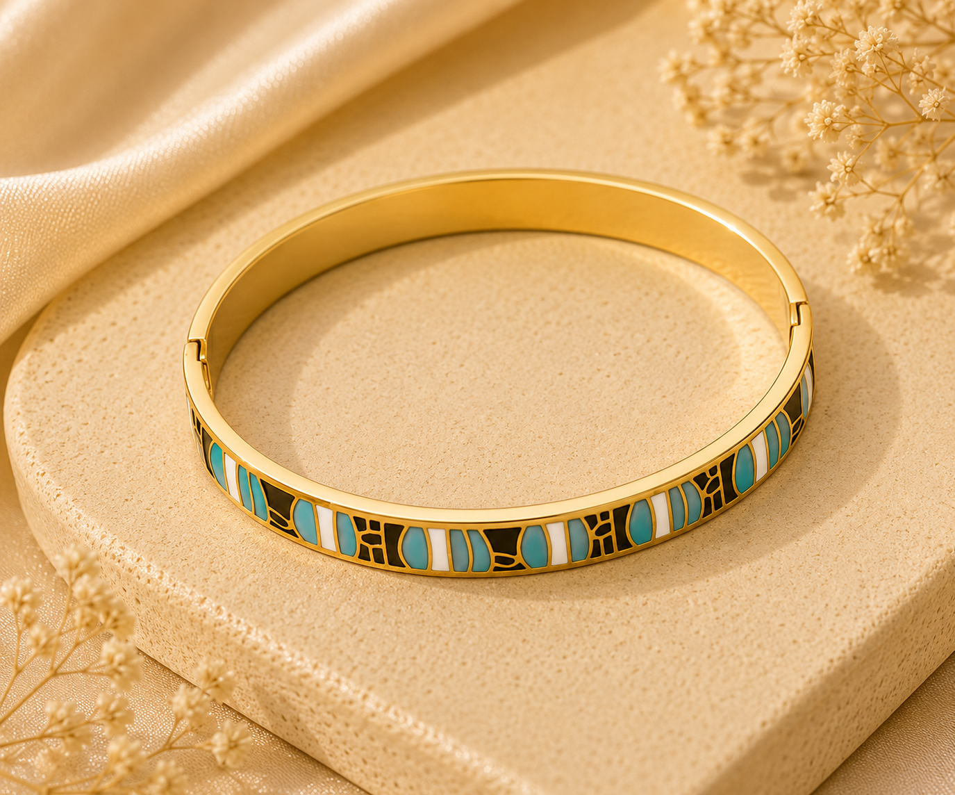 Gold bracelet with colorful stones on a beige fabric background